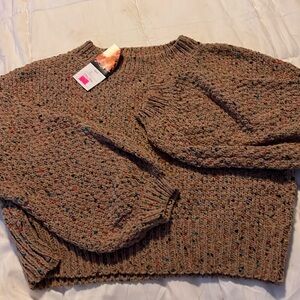 Waist length women’s sweater.  Size L.  Never worn.  NWT